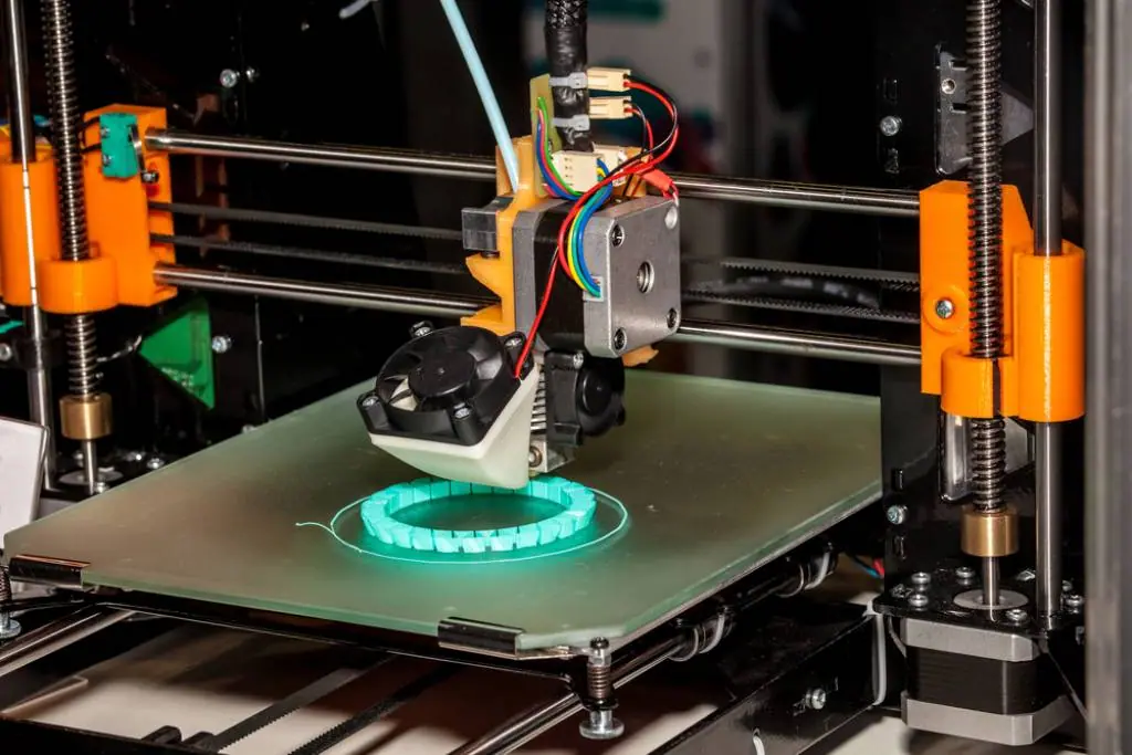 Additive manufacturing machine building a part, used in design and process development.